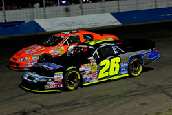 Greg Pursley #26 and David Mayhew competing for first place in the Stockton 150